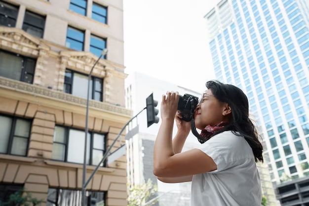 Woman photographing a building