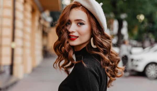 woman in a beige cap and black sweater on the street